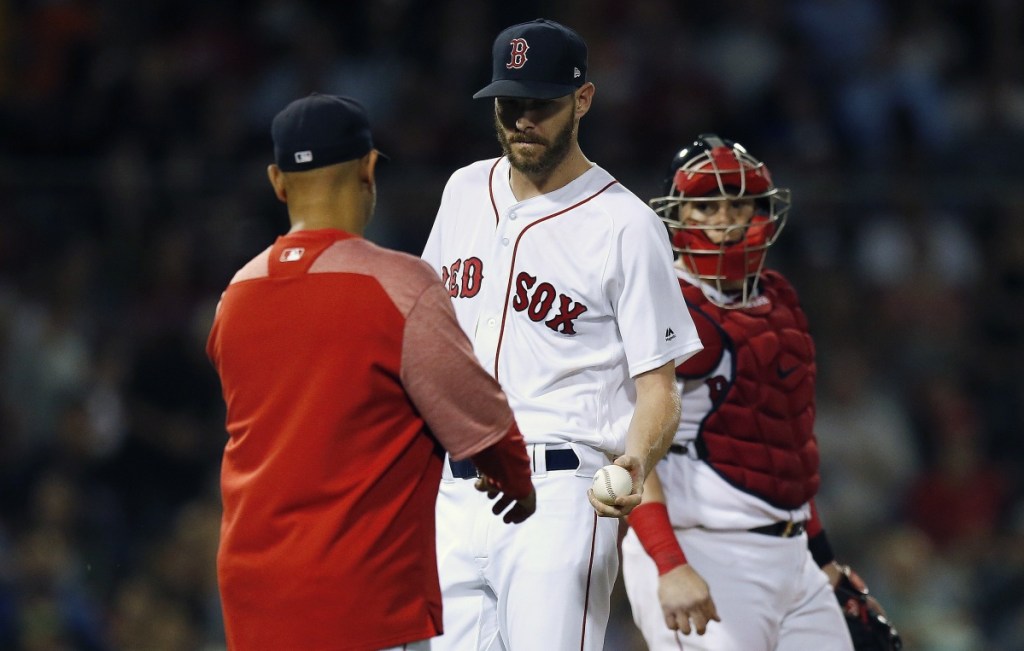 Boston Red Sox manager Alex Cora, left, relieves Chris Sale, center, during the fifth inning of the second game of a doubleheader against the Baltimore Orioles in Boston on Wednesday night. (AP Photo/Michael Dwyer)