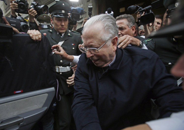 The Rev. Fernando Karadima is escorted from court after testifying in a case that three of his victims brought against the country's Catholic Church in Santiago, Chile, in 2015.