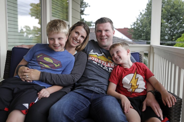 Tricia and Steve Schalekamp with their sons Evan, 9, left, and Alex, 6, in Seattle. The family paid at least $500 in nonrefundable waiting list fees for preschool for Evan.