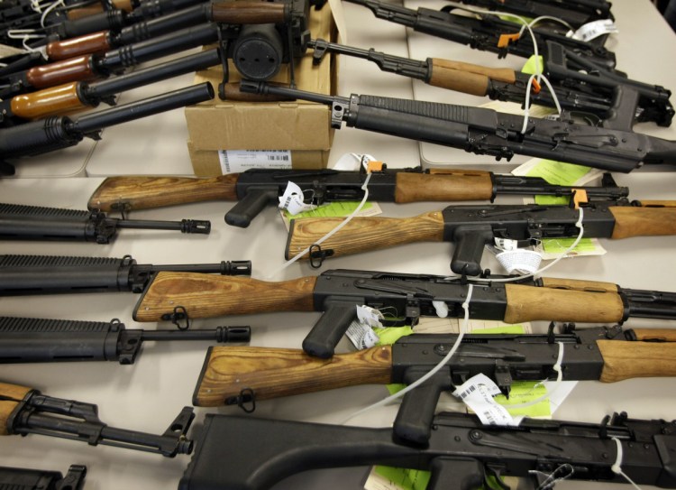 A cache of seized weapons that were to be smuggled from the United States into Mexico is displayed in Phoenix in this 2011 file photo.