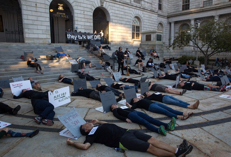 A group of 57 people lay on the ground outside Portland City Hall on Friday for an overdose prevention "die in." The 57 people symbolized the 57 opioid overdose deaths in Portland last year.
