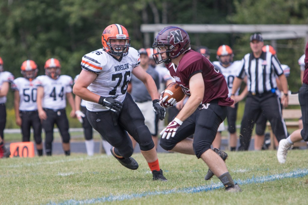 Nokomis' Alex Costedio carries the ball past Winslow's Ronan Drummond during a game Saturday in Newport.
