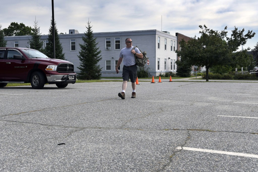 Augusta Police Officer Scott Taylor walks Tuesday to his car in the satellite parking lot of the agency's station after completing a shift. The city of Augusta is considering the lot as the site for a new headquarters for the department, along with several other locations, including downtown.