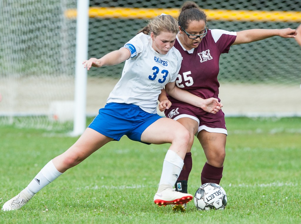 Oak Hill's Julia Noel, left, muscles in on Monmouth's Alexis Trott during Tuesday afternoon's girls soccer game in Monmouth.