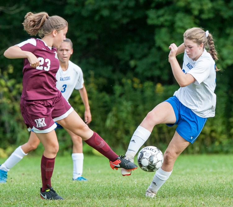 Monmouth's Amaya Bauer, left and Oak Hill's Julia Noel battle for the ball during Tuesday's game in Monmouth.