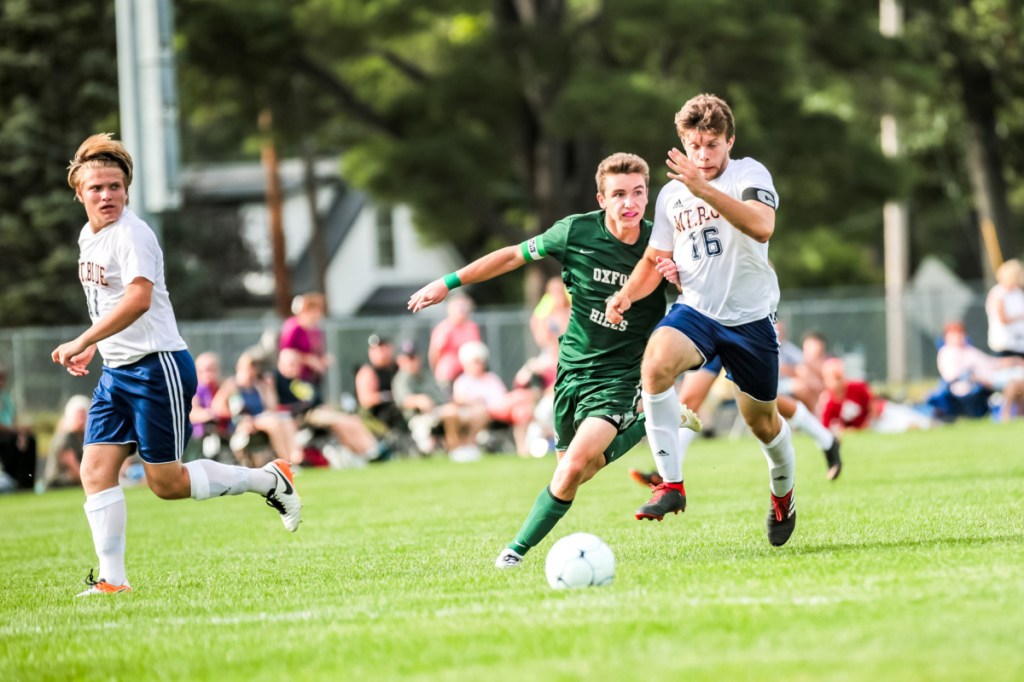 Mt. Blue defender Dom Giampietro keeps Oxford Hills' Spencer Strong away from the ball during the first half at Gouin Athletic Complex in Paris on Tuesday.