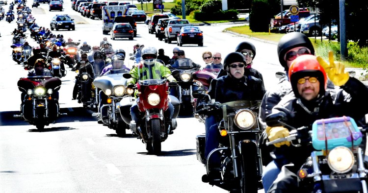 Hundreds of motorcycles and riders bearing gifts for children ride on Sept. 14, 2014, on Upper Main Street in Waterville en route to Augusta to deliver toys during the annual Toy Run event.