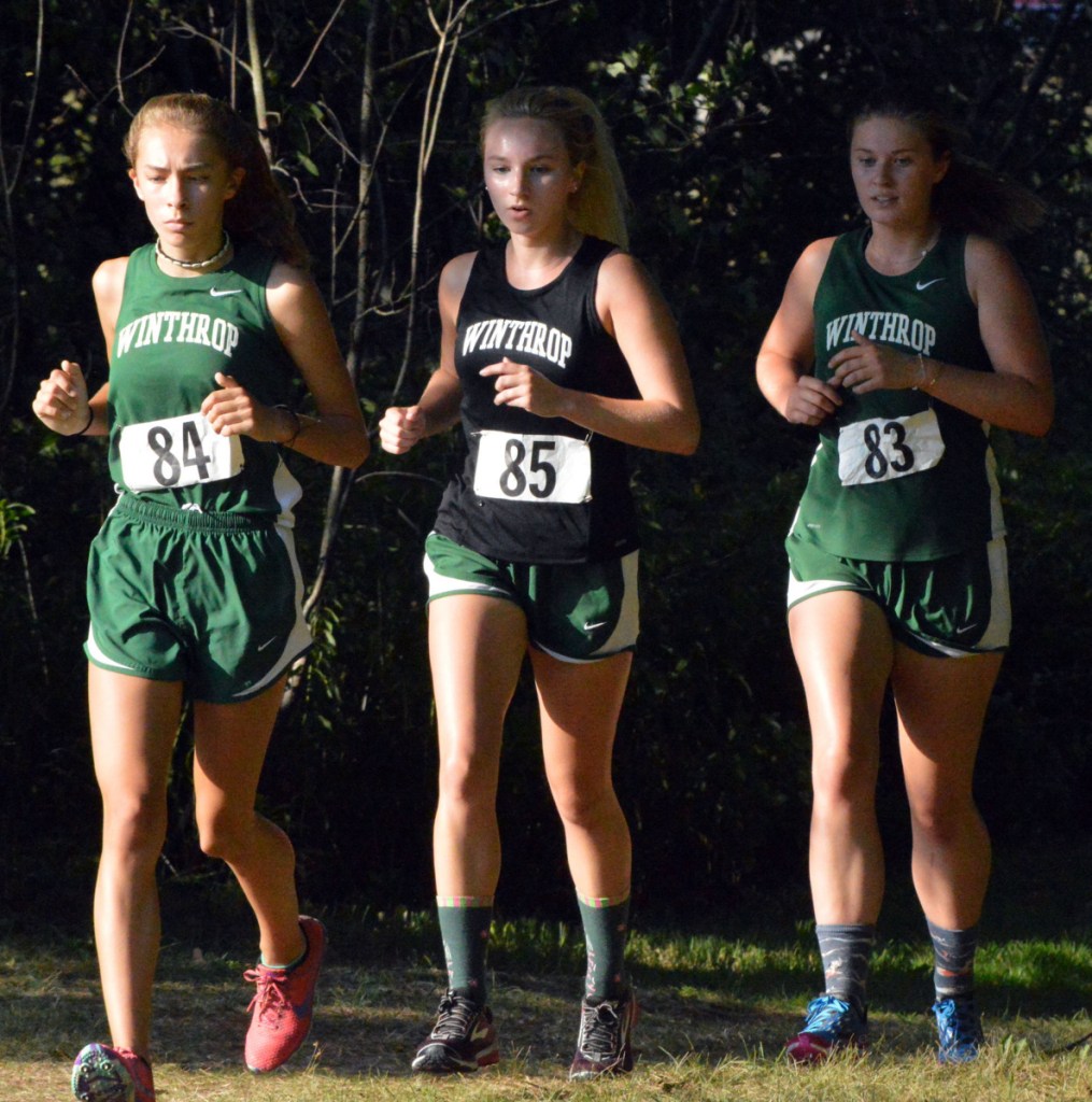 Winthrop's Maya Deming (84), Alexis Emery (85) and Sam Allen (83) run in a pack during a meet at the University of Maine in Augusta.