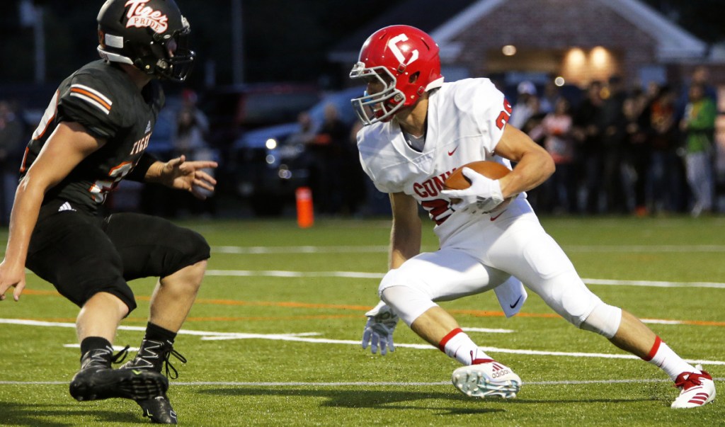 Portland Press Herald photo by Ben McCanna 
 Cony's Reed Hopkins, right, looks for a way around Biddeford's Kurtis Edgerton during a game Friday night in Biddeford.