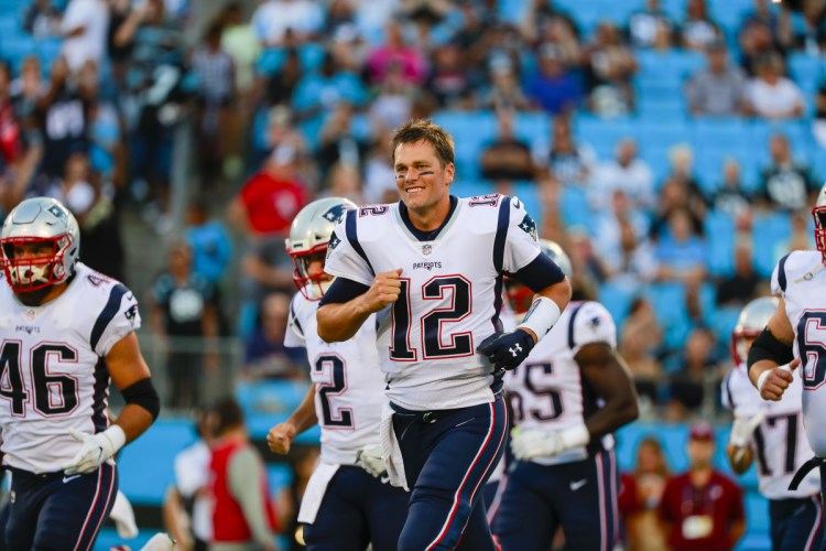 New England Patriots quarterback Tom Brady leads the team onto the field against the Carolina Panthers during a preseason game in Charlotte, Noth Carolina.