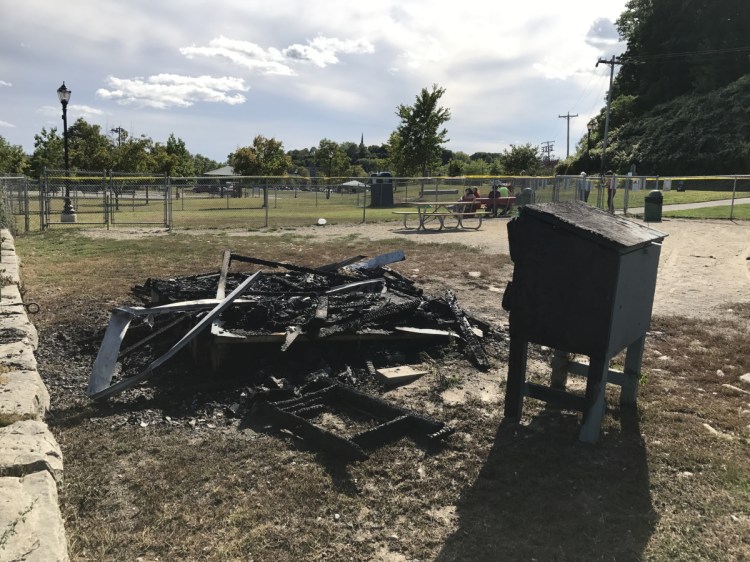 Charred rubble is all that remains Saturday of a shelter that once enabled dog owners to see protection in bad weather while their dogs ran around in a fenced enclosure at Mill Park in Augusta. The shelter burned Friday night, and police are investigating it as a likely case of arson.