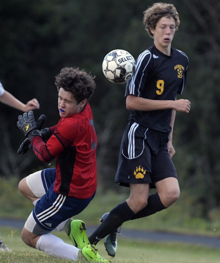 Maranacook's Richard Down can't get a shot by Medomak Valley's Aiden Starr during a soccer game Tuesday in Readfield.