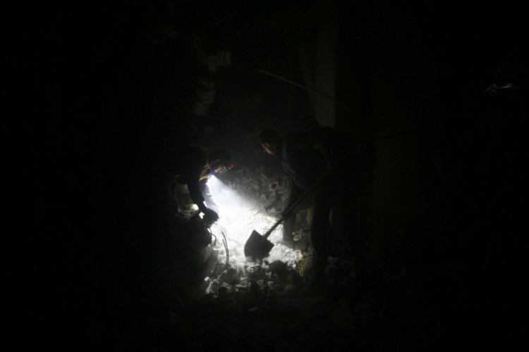 Civil defence workers look for survivors Feb. 22 in a shelter after Russian airstrikes destroy it in the besieged town of Douma, Syria.