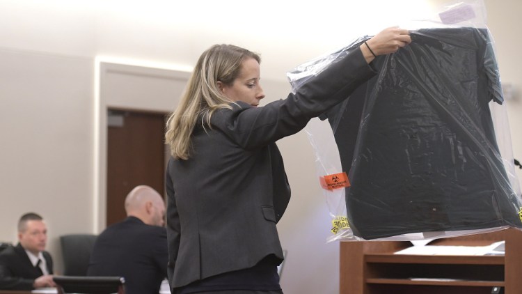 Scott Bubar, left, watches Assistant District Attorney Alisa Ross display a shirt Monday that she claims Bubar was wearing during a shootout with police on May 19, 2017, in Belgrade. Bubar is standing trial for his alleged attempted murder of a sheriff's deputy during the shootout, which killed his father.