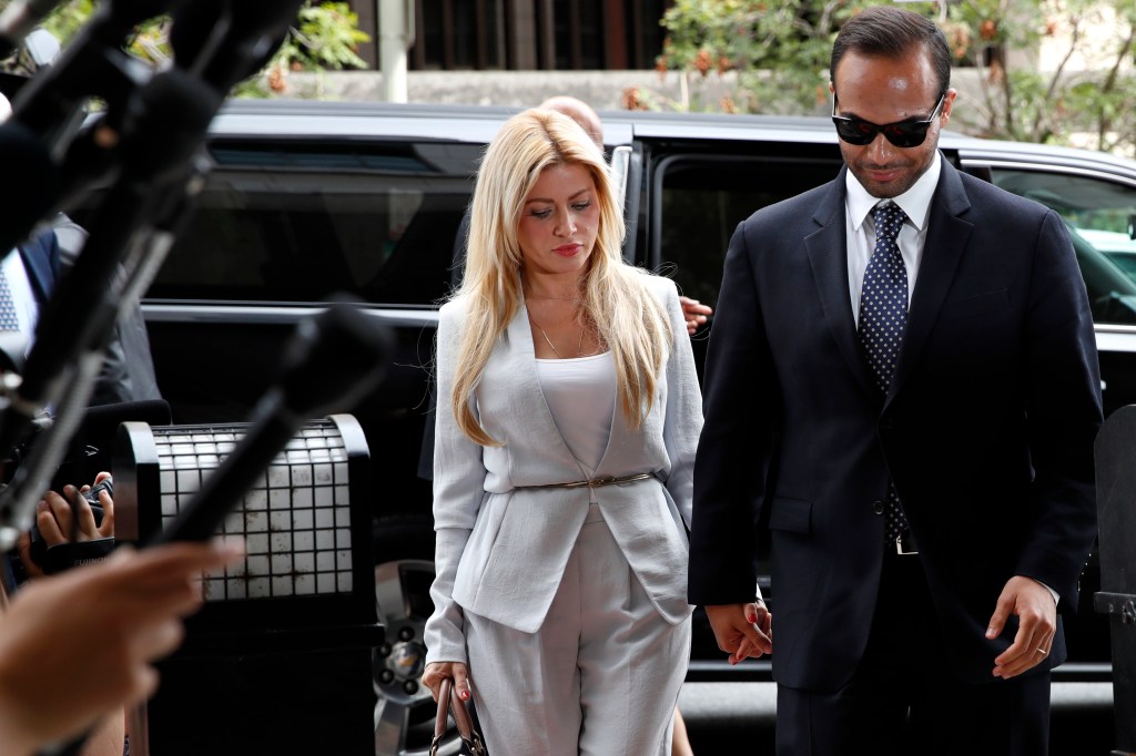 Former Donald Trump presidential campaign foreign policy adviser George Papadopoulos, right, who pleaded guilty to one count of making false statements to the FBI during the agency's Russia probe, holds hands with his wife Simona Mangiante, as they arrive at federal court for sentencing, Friday in Washington. 