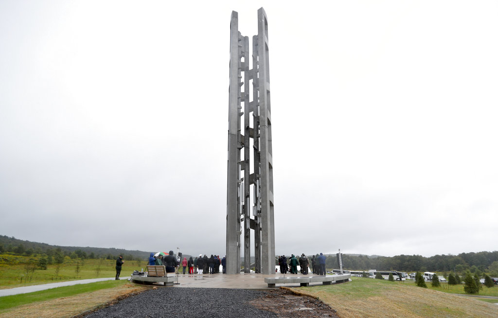 People attending the dedication stood around the 93-foot tall Tower of Voices at the Flight 93 National Memorial in Shanksville, Pa., on Sunday, September 9, where the tower contains 40 wind chimes representing the 40 people that perished in the crash of Flight 93 in the terrorist attacks of Sept. 11, 2001. 