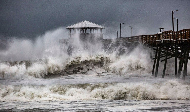 Waves slam the Oceana Pier & Pier House Restaurant in Atlantic Beach, N.C., on Thursday as Hurricane Florence approaches the area. 