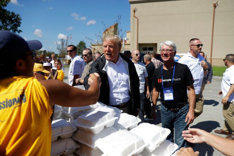 President Donald Trump visits the Temple Baptist Church, where food and other supplies are being distributed during Hurricane Florence recovery efforts, Wednesday.