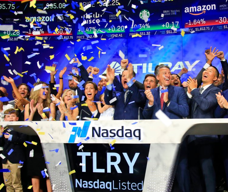Brendan Kennedy, third from right in front, CEO and founder of British Columbia-based Tilray Inc., a major Canadian marijuana grower, leads cheers as confetti falls to celebrate his company's IPO (TLRY) at Nasdaq in New York in July. Investors are craving marijuana stocks as Canada prepares to legalize pot next month, leading to giant gains for Canada-based companies listed on U.S. exchanges. 