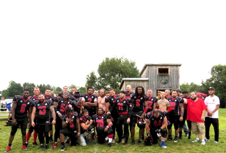 The Twin City Riot of the New England Football League pose for a team photo in August at their new home field in Athens.