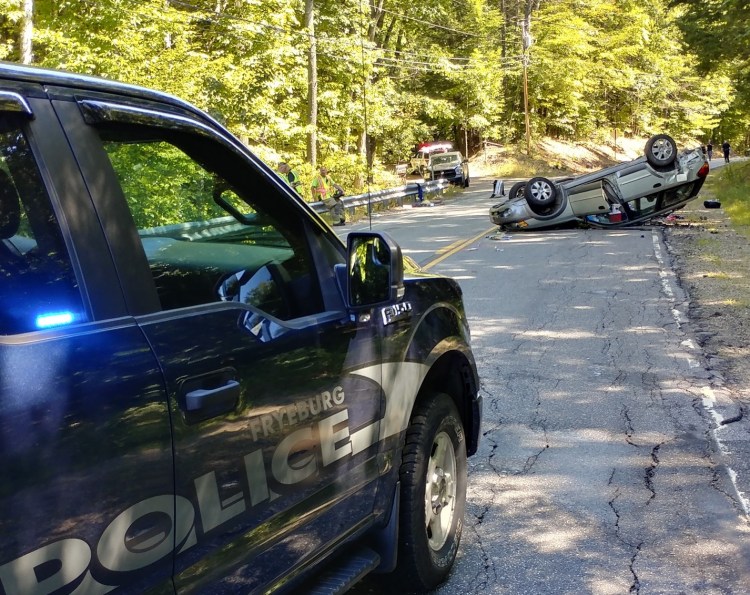 One of the vehicles involved in a crash on Route 302 in Fryeburg on Saturday rests on its roof. A woman and child were in critical condition on Saturday at a Portland hospital.  