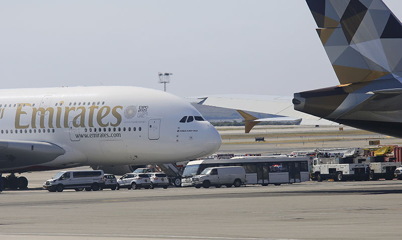 Emergency response crews gather outside a plane at JFK Airport amid reports of ill passengers aboard a flight from Dubai.