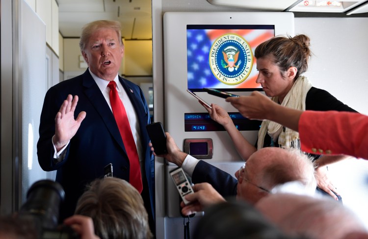 President Donald Trump speaks to reporters on Air Force One Friday. 