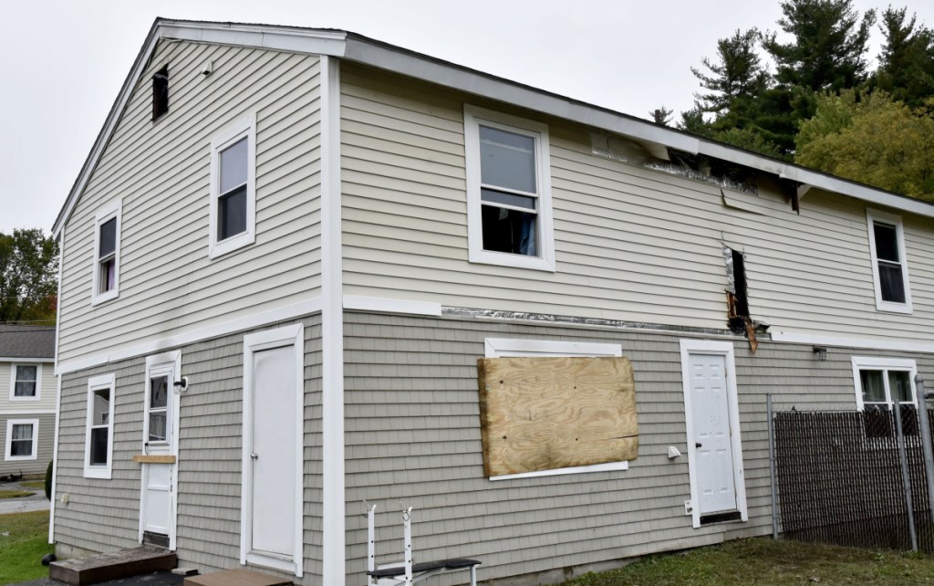 Windows have been boarded up and blackened holes were left from a grease fire that damaged this home at 16 Crawford St. in Waterville on Tuesday.