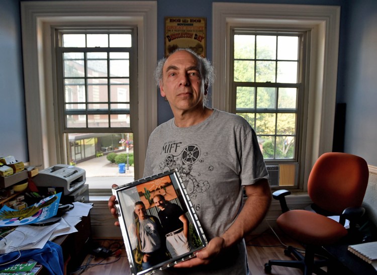 Maine International Film Festival programmer Ken Eisen, one of the original founders of Railroad Square Cinema in 1978, poses in June 2017 with a portrait of himself and director Jonathan Demme in his MIFF office on Main Street in Waterville. Demme was honored at the 20th annual Maine International Film Festival.