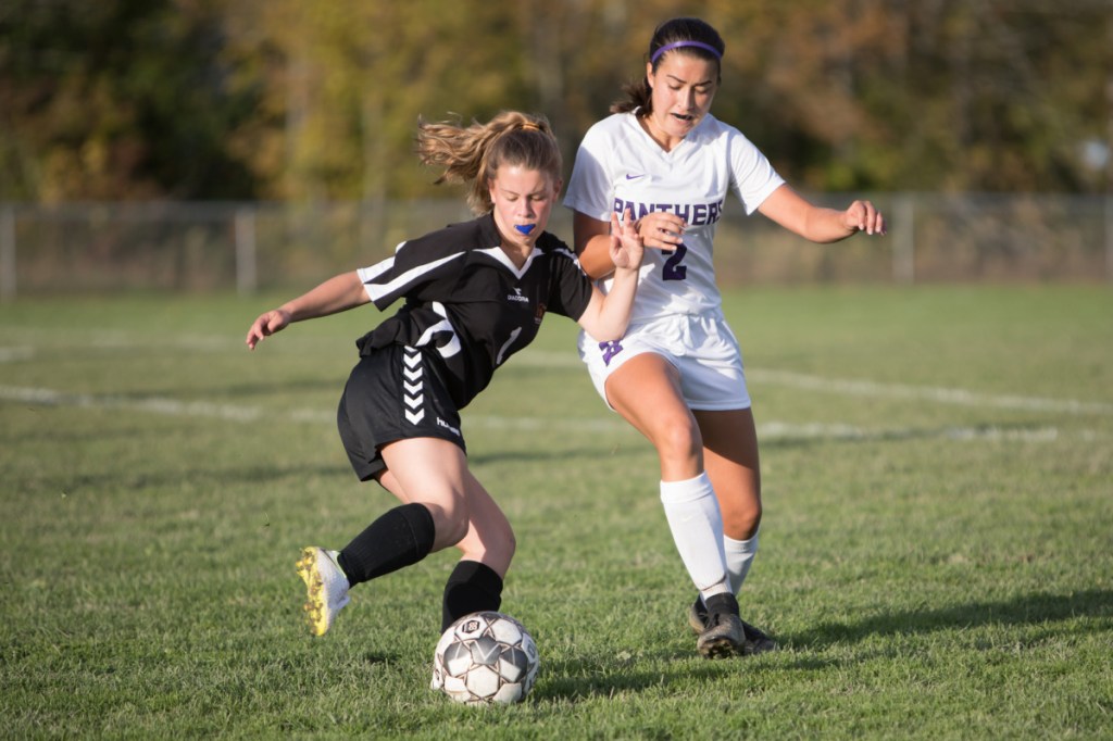 Winslow's Hannah Dugal, left, takes control of the ball as Waterville defender Lauren Pinnette closes in during a Kennebec Valley Athletic Conference Class B game Friday afternoon in Winslow.