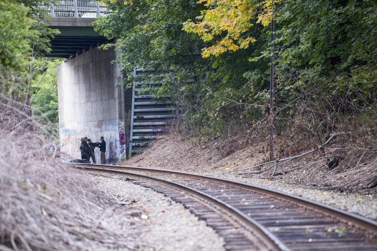 Investigators with the Maine State Police and Waterville police investigate the scene where a man was found dead under the over pass of the railroad tracks at North Street in Waterville on Thursday. Authorities identified the man as Anthony Kershner, 46, of Center Street in Waterville.