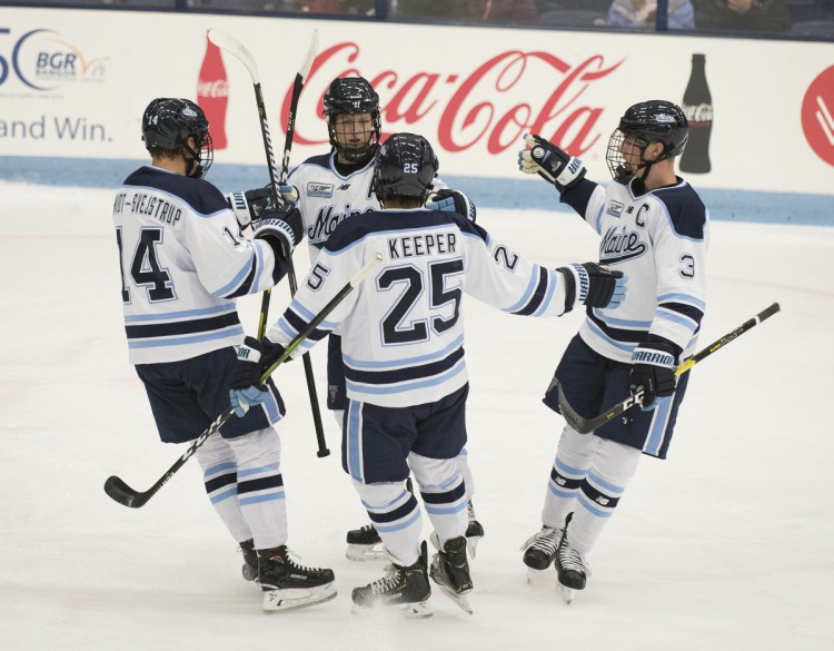 From left to right, UMaine's Jacob Schmidt-Svejstra, Mitchell Fossier, Brady Keeper and Rob Michel celebrate Fossier's second goal of the night against UPEI at Alfond Arena in Orono on Monday.