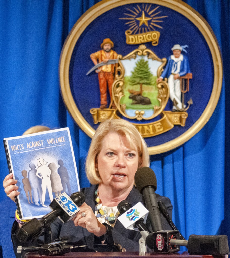 Deputy Attorney General Lisa Marchese, center, speaks during news conference on Tuesday in The Hall of Flags of the Maine State House in Augusta.
