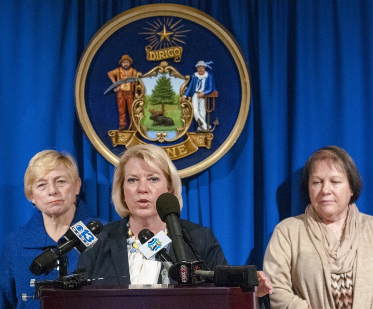 Deputy Attorney General Lisa Marchese, center, speaks during news conference on Tuesday in The Hall of Flags of the Maine State House in Augusta. Attorney General Janet Mills, left, and Barbara Theriault, mother of the late Amy Theriault, also spoke at the event.
