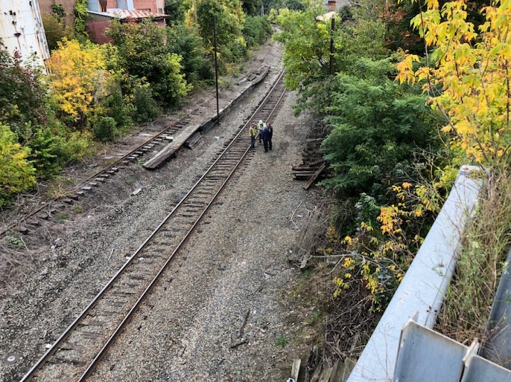 Investigators with the Maine State Police and Waterville police investigate the scene where a man was found dead under the overpass of the railroad tracks at North Street. Authorities later identified the man as Anthony Kershner, 46, of Waterville.