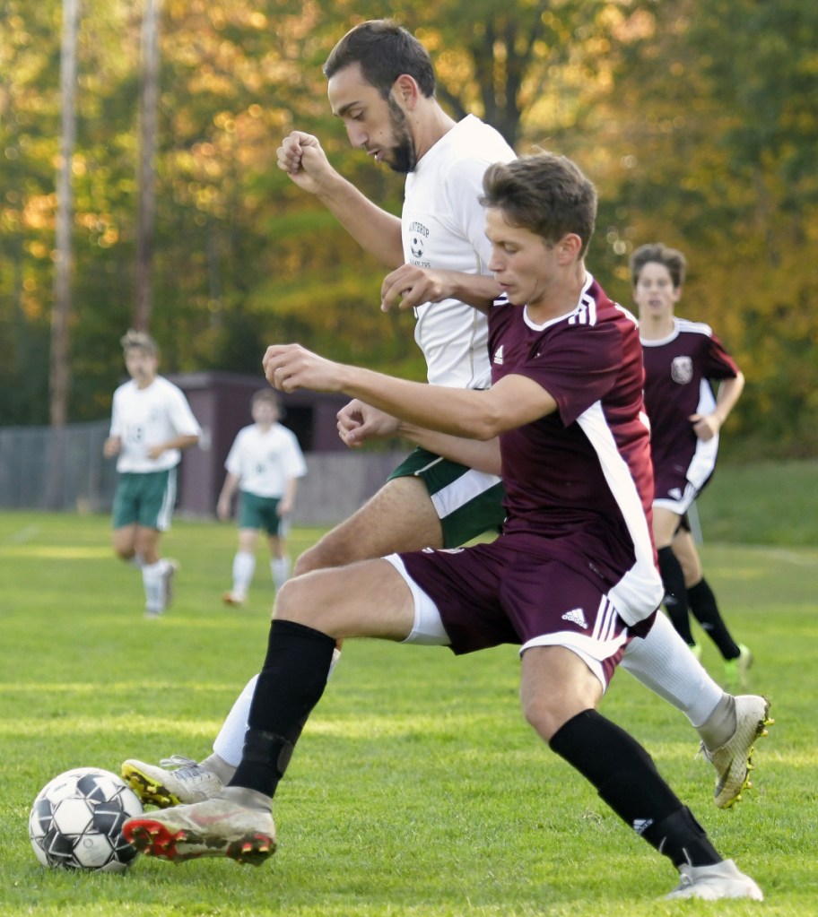 Monmouth's Corey Armstrong, right, tries to get past Winthrop's Jared McLaughlin during a Mountain Valley Conference soccer game Tuesday in Monmouth.