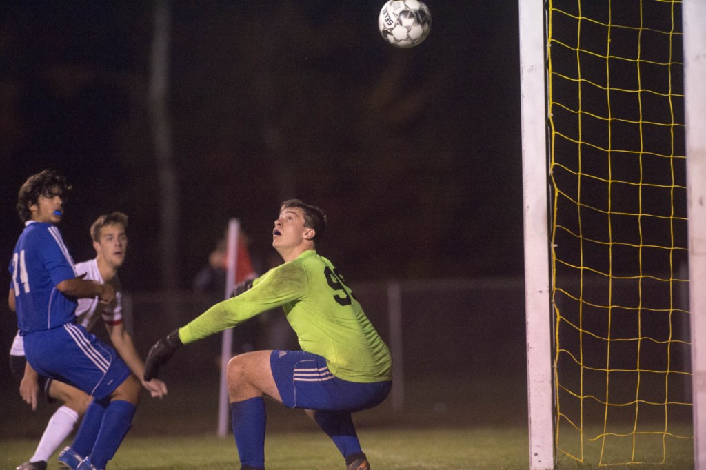 Mt. Abram goalie Jack Deming can't stop this shot during a game against Hall-Dale on Tuesday night in Strong.