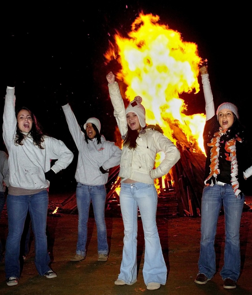 Gardiner cheerleaders do a routine in front of  a giant bonfire on the Gardiner waterfront prior to the 2007 conference championship game against Winslow. It was common for schools to hold big pep rallies prior to big games, including playoff games and the annual Cony-Gardiner showdown.