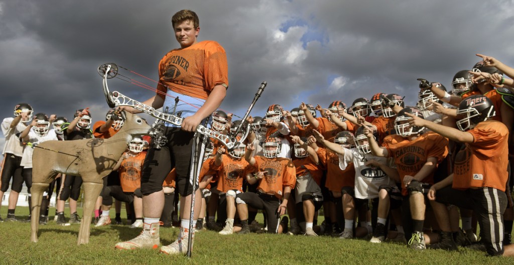 Gardiner lineman Brad Sandelin stands with his team at practice on Wednesday in Gardiner. The varsity football player is also a world champion archer.
