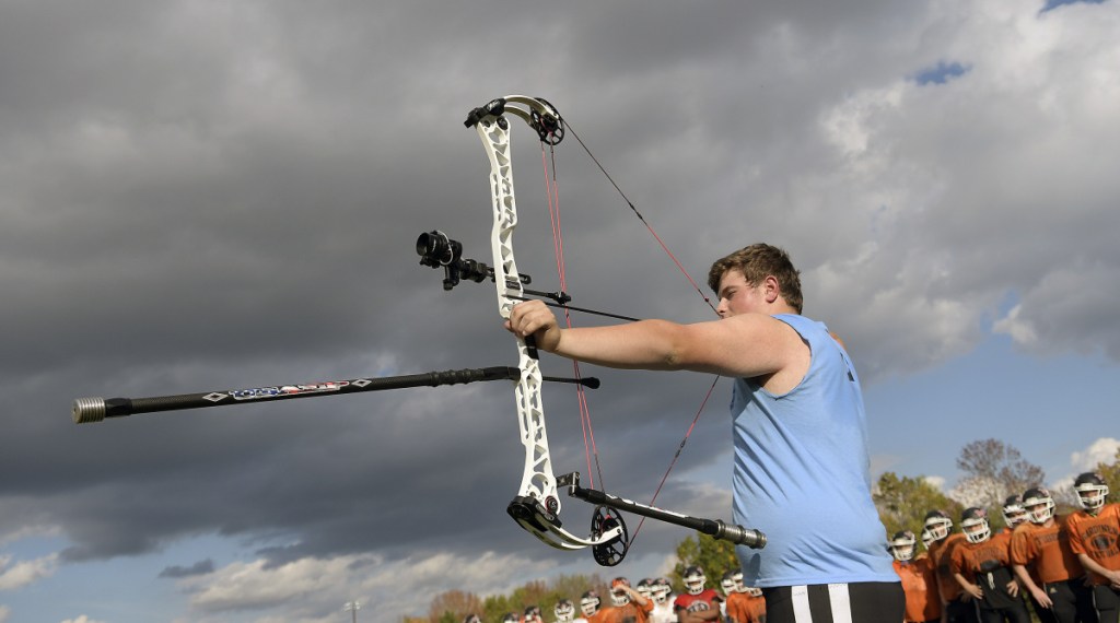 Gardiner Area High School lineman Brad Sandelin draws a bead with his bow before practice Wednesday in Gardiner. The varsity football player is also a world champion archer.
