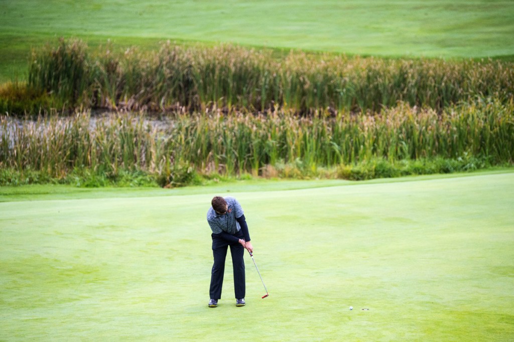 Staff photo by Michael G. Seamans 
 Gardiner's Cody Rizzo sinks his putt on the 18th hole at Natanis Golf Course in Norridgewock on Oct. 2.