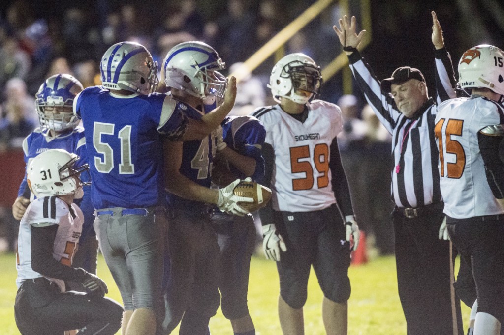 Lawrence's Alex Higgins (45), celebrates his first quarter touchdown against Skowhegan with teammate Michenzie Steeves (51) in Fairfield on Friday.