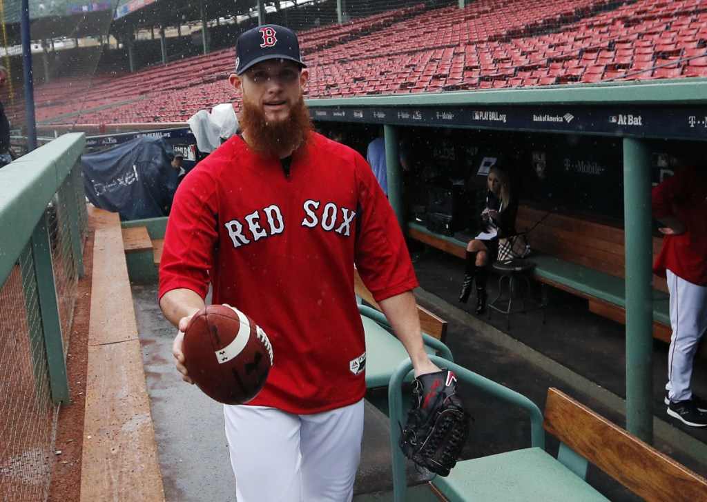AP photo 
 Boston Red Sox closer Craig Kimbrel walks into the dugout as it starts to rain during a workout Thursday at Fenway Park.