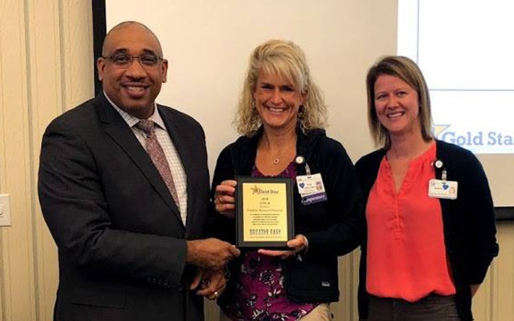From left, Kenneth I. Lewis, senior director of the Center for Tobacco Independence, presents a Tobacco-Free Hospital Gold Star Standards of Excellence Award to Heidi Hilton, of Franklin Memorial Hospital, and Andrea Richards, of the Healthy Community Coalition.