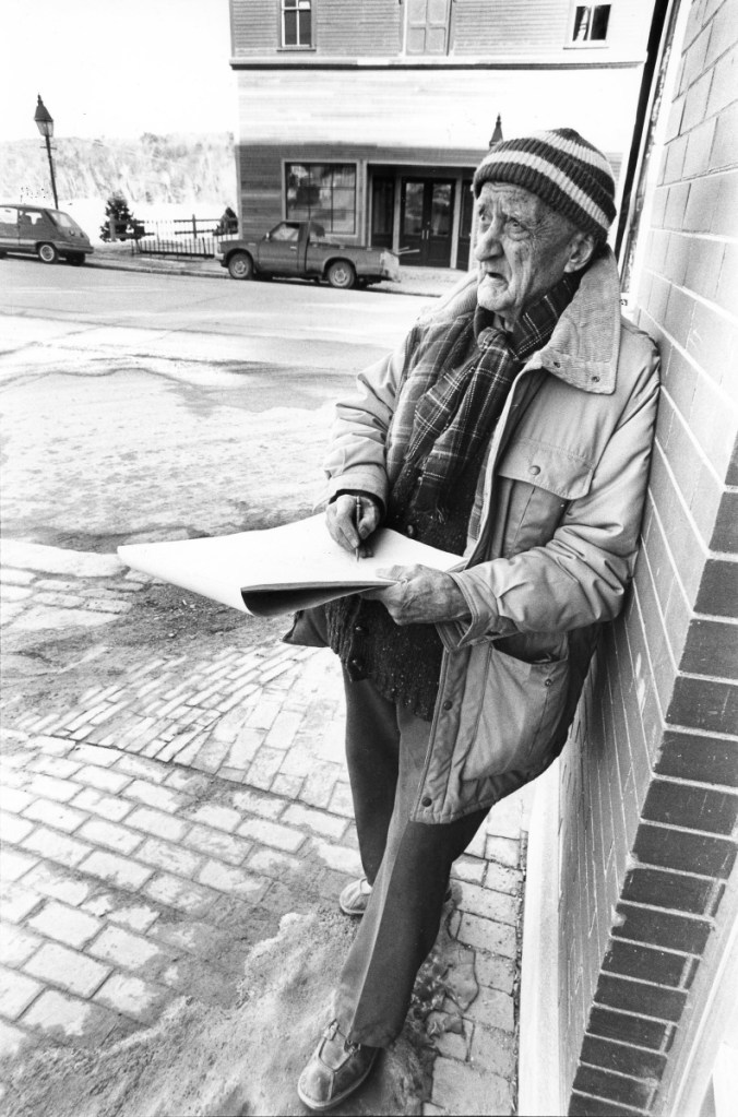 Renowned Hallowell artist Ray Skolfield draws at the corner of Winthrop Street and Water Street in March 1990. The new location of the Harlow Gallery sits in the background. Skolfield's work has been featured in the Smithsonian Art Museum.