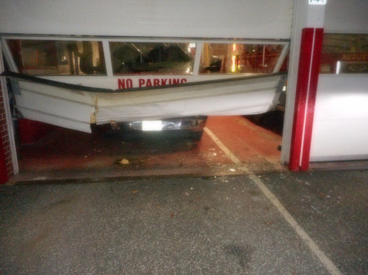 A car hit a bay door at Daryl Parker Wells Fire Station on Bangor Street in Augusta on Sunday. Thomas Cloutier, 57, was arrested in connection with the incident.
