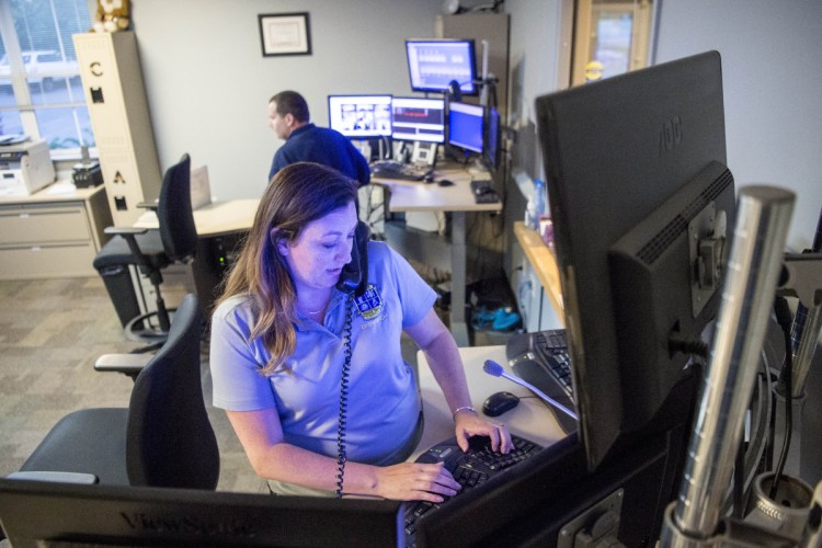 Police dispatcher Kecia Blaisdell answers a call June 15 at the Waterville police dispatch center at the Waterville Police Department.