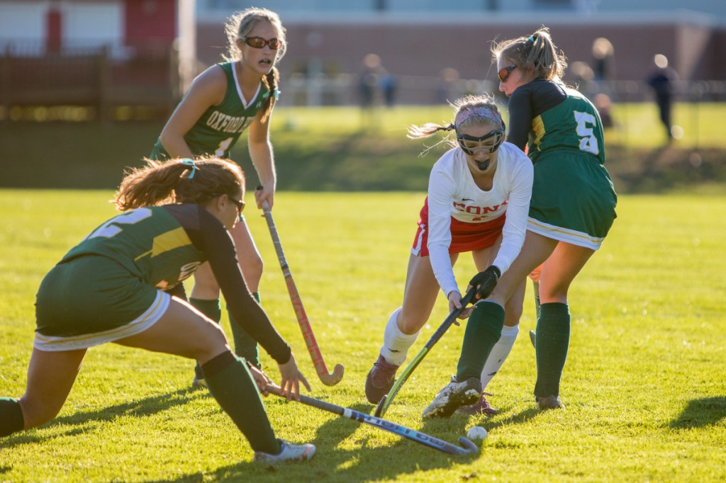 Photo by Jennifer Bechard 
 Cony's Julia Reny, center, fights for the ball while being defended by Oxford Hills' Lauren Merrill, right, and Kate Bowen, left, in a Class A North quarterfinal game Tuesday in Augusta.