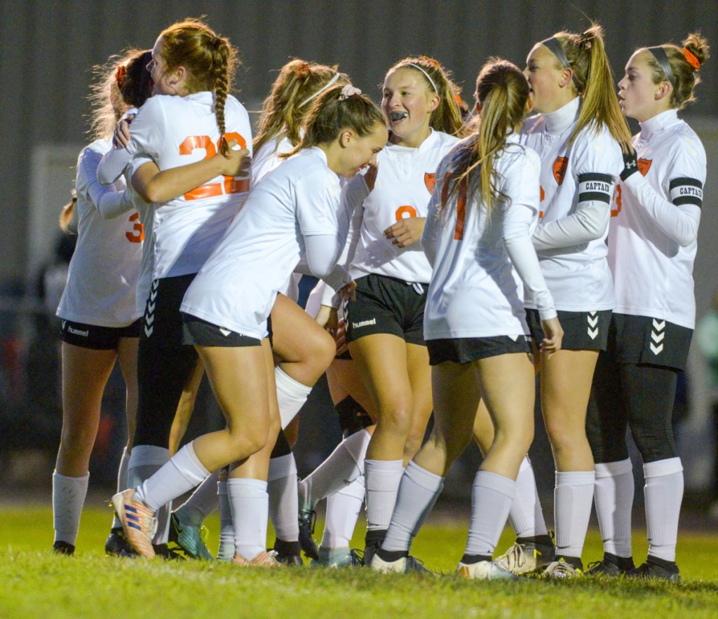 The Black Raiders celebrate after Desiree Veilleux scored a goal for a 1-0 lead against Maranacook on Tuesday in Readfield.