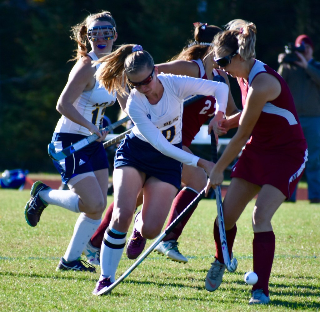 Mt. Blue senior forward Ellie Pelletier (10) and Bangor midfielder Makenzie Thompson (7) battle for the ball in a Class A North field hockey quarterfinal at Caldwell Field in Farmington on Tuesday afternoon.